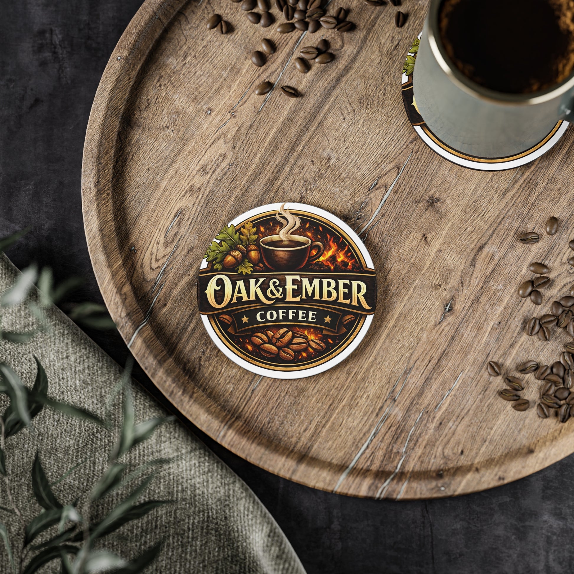 Wooden tray with a cup of coffee, coffee beans, and an 'Oak & Ember Coffee' coaster.